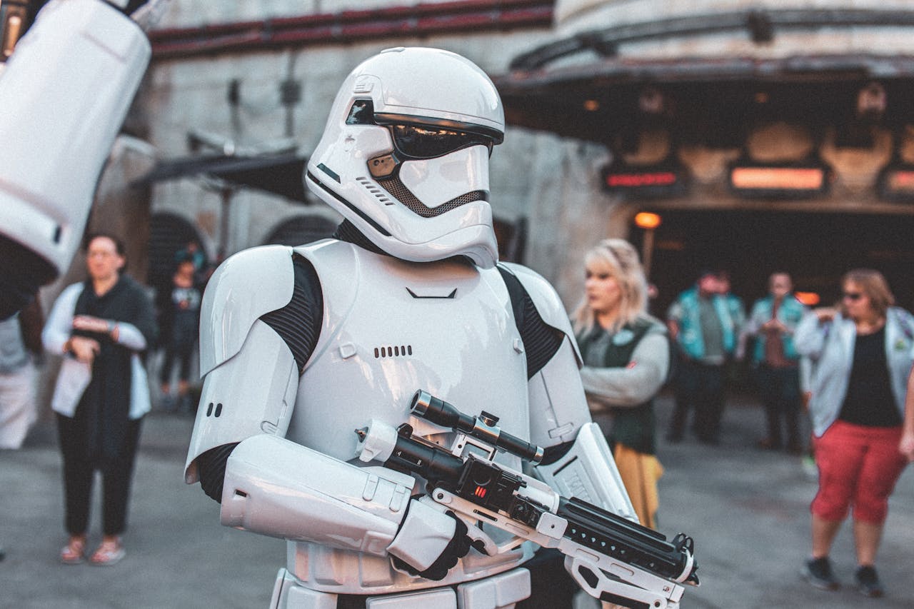 gallery-img-04 Stormtrooper character in costume at a busy sci-fi themed park event.