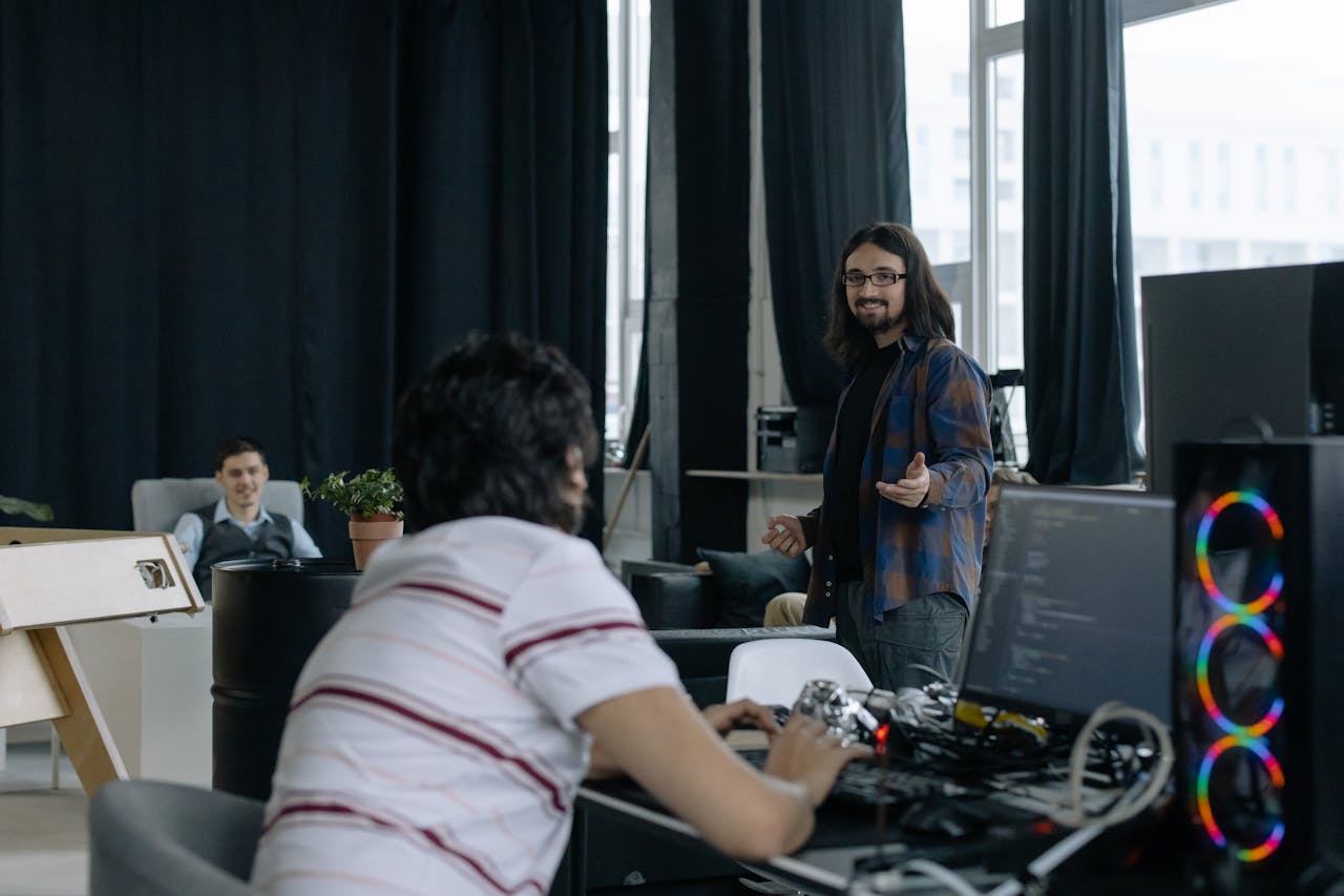 why-choose-us-img Young professionals collaborating in a modern software company office space.