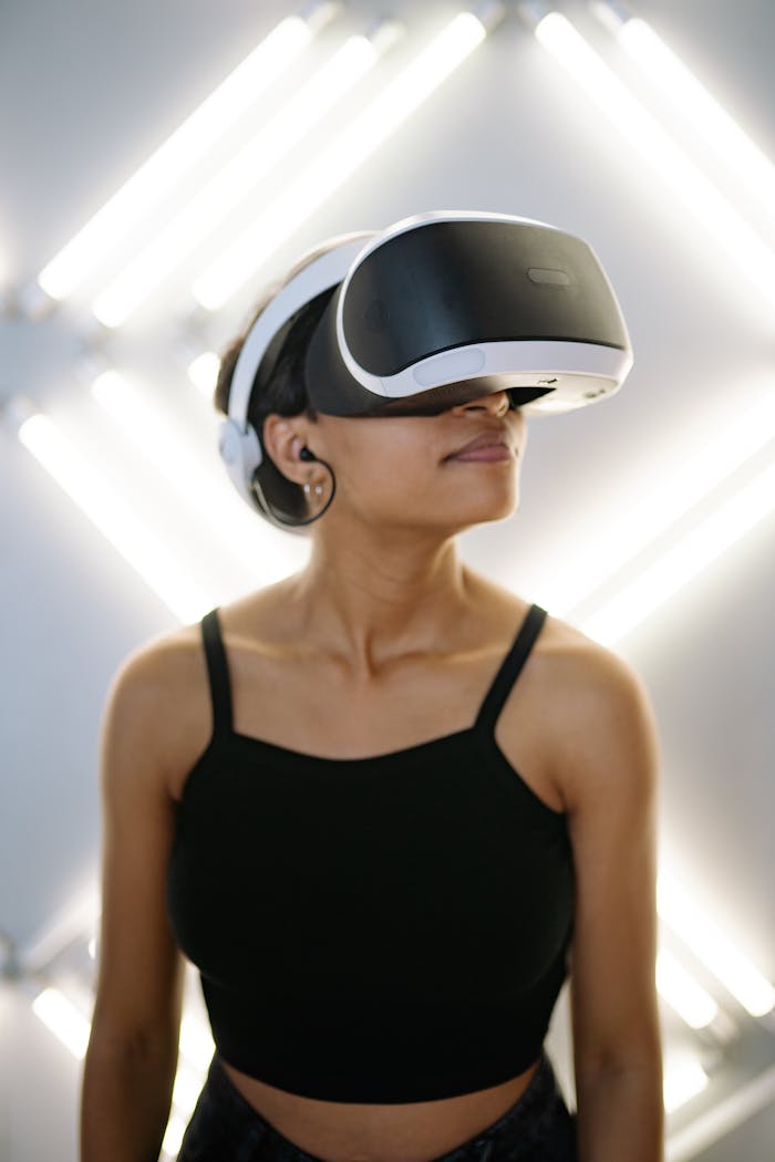 hero-gallery-03 A woman wearing a VR headset immersed in a virtual experience, against a modern background.